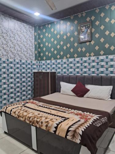 een bed in een kamer met een blauwe muur bij Nidhi dham inn in Vrindāvan