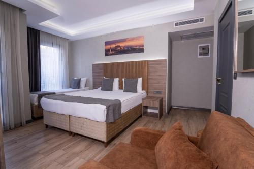 a hotel room with a bed and a couch at The Omiya Hotel in Istanbul