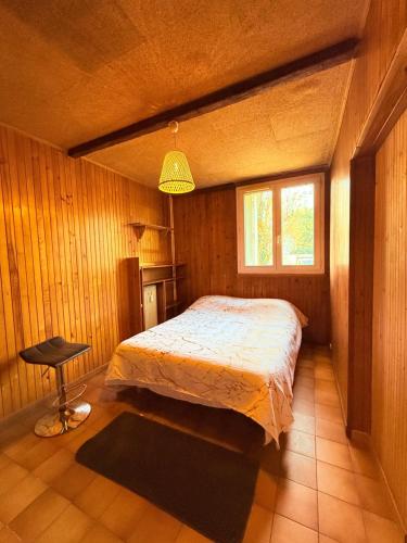 a bedroom with a bed and a chair in it at Positive country in Aulnay-sous-Bois