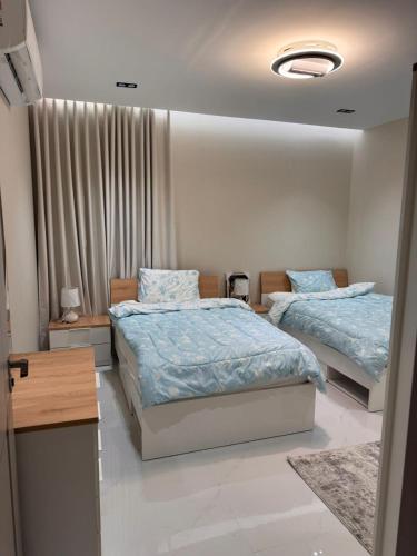 a bedroom with two beds and a window at شقة قباء in Medina