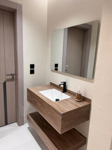 a bathroom with a sink and a mirror at شقة قباء in Medina