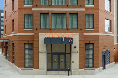a building with a sign on the front of it at Canopy By Hilton Ithaca Downtown in Ithaca
