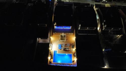 an aerial view of a pool at night with lights at TUSCIA RELAx MARE in Civitavecchia
