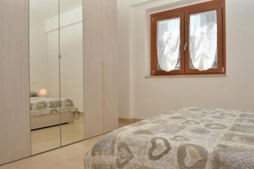 Кровать или кровати в номере Appartamento Arancio