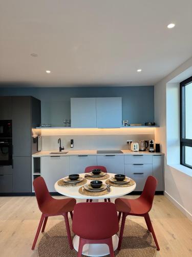 a kitchen with a table and chairs in a room at 02 Arena, Thames Riverside Retreat in London
