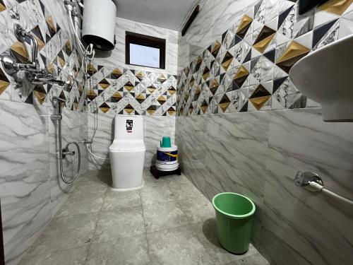 a bathroom with a toilet and a sink at Sawra Homestay in Chakrāta