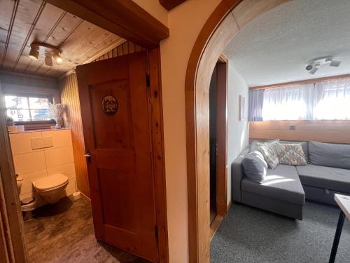 a living room with a blue couch in a room at Sonne in Klosters