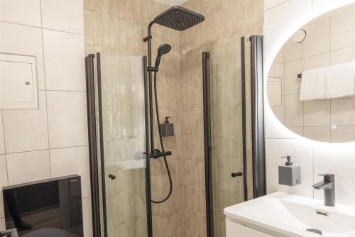 a bathroom with a shower and a sink at Scandic Victoria Florø in Florø