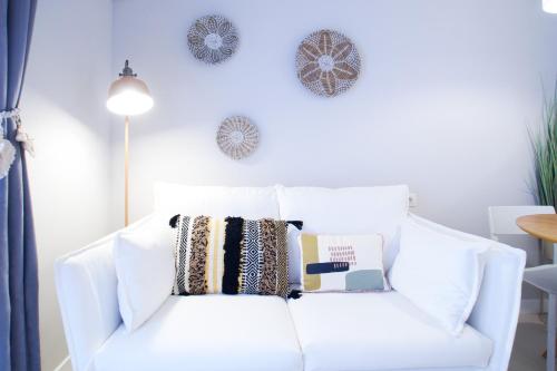 a white couch with pillows on it in a living room at Budget Beach Studio 24 in Calonge