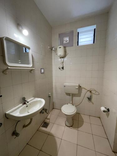 a bathroom with a toilet and a sink at Stay Guru Resort Farm Villa in Bhuj