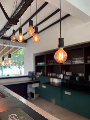 a bar with lights hanging from the ceiling at Villa Talay - 5 Bedroom Beachfront Villa in Talalla South