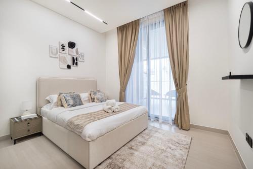 a bedroom with a bed with a teddy bear on it at Elegant 2BR With Modern Design Near to Circle Mall in Dubai