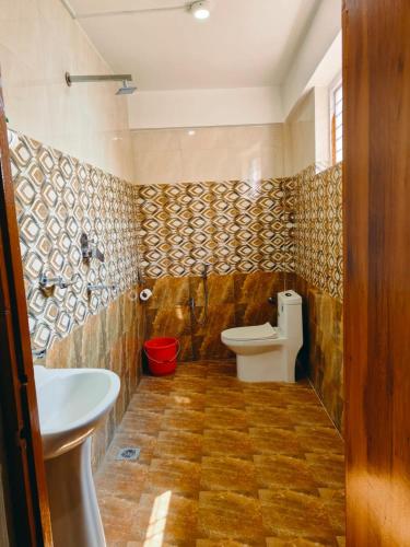 a bathroom with a toilet and a sink at Hotel Sonam in Dhulikhel