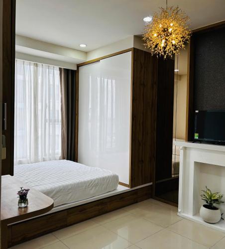 a bedroom with a bed with a mirror and a tv at The Lume Studio - Tresor D4 in Ho Chi Minh City