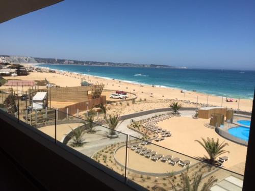 a view of a beach and the ocean from a building at Arenamaris Apartment in Algarrobo