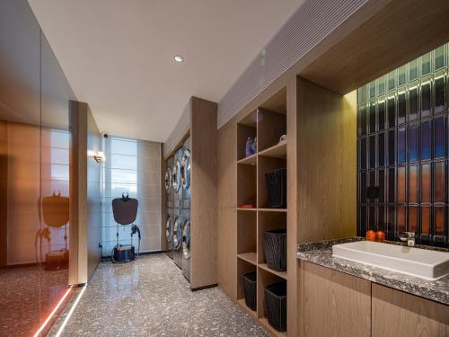 a large bathroom with a sink in a room at Arthur Hotel Baiyun Station Xinshixu Subway Station Guangzhou in Guangzhou