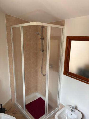 a shower stall in a bathroom with a sink at Ca baracot in Lanzo Torinese