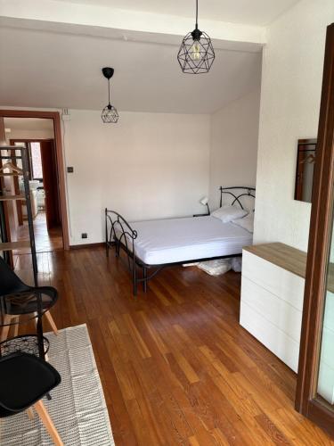 a bedroom with a bed and a wooden floor at Ca baracot in Lanzo Torinese