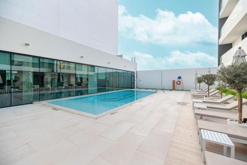 a swimming pool on the roof of a building at Elegant 2BR With Modern Design Near to Circle Mall in Dubai