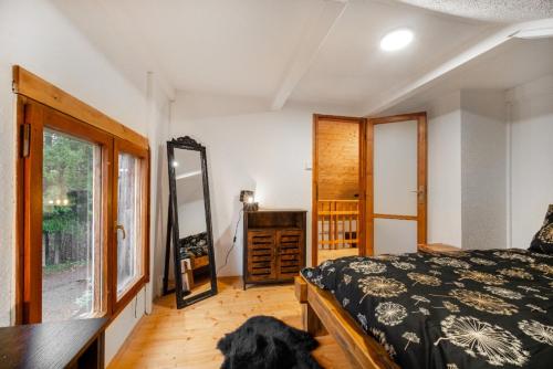 a bedroom with a bed and a dog laying on the floor at LES-wellness in Pastviny