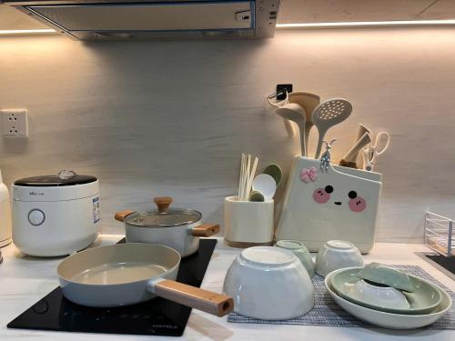 a counter top with pots and utensils on it at Gia An Homestay in Phú Thú