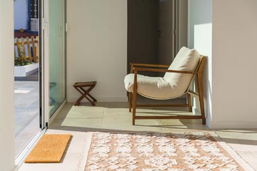 a chair sitting in a room next to a door at GuestReady - Hillside Escape I in Câmara de Lobos