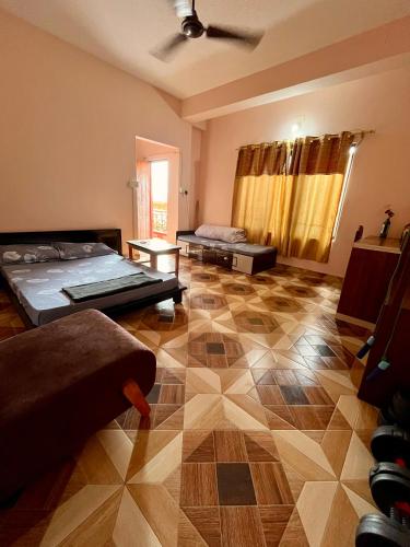 a living room with two beds and a floor at Amelie Apartments and Stay Inn in Pokhara