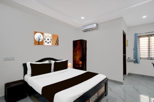 a bedroom with a black and white bed at Super Townhouse Oak Bachupally Medical College Formerly SV Hotels in Lingampalli