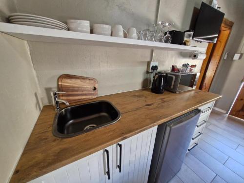a kitchen with a sink and a counter top at Coniston Villa in Colesberg