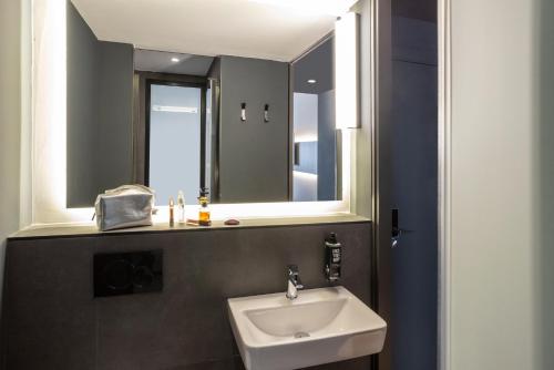 a bathroom with a sink and a mirror at ibis Madrid Norte Las Tablas in Madrid