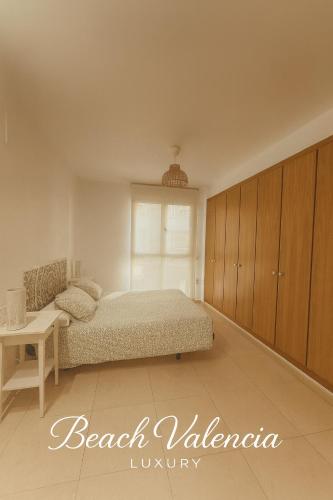 a bedroom with a bed and a table at BEACH VALENCIA LUXURY A40-13 Apartment with terrace and sea views in Valencia