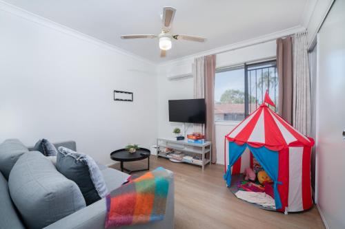 a living room with a play tent in it at 3BR Cozy Sunnybank Hills Home in Brisbane