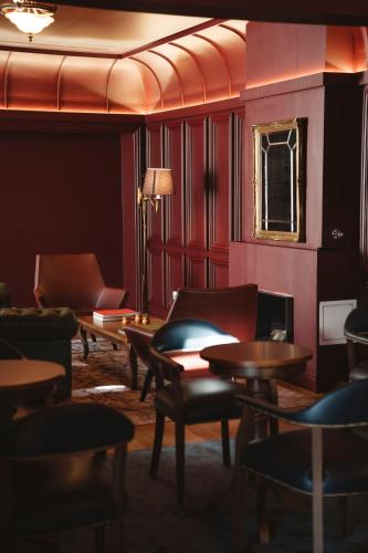 a room with chairs and tables and a mirror at The Vinea Collection Hotel by Piamonte Hotels in Monção