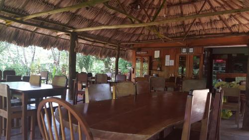 a dining room with a large table and chairs at Clarissa Falls Resort in San Ignacio