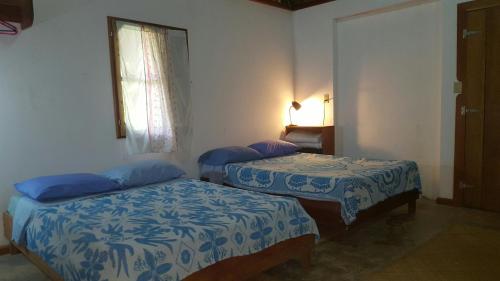a bedroom with two beds in a room at Clarissa Falls Resort in San Ignacio