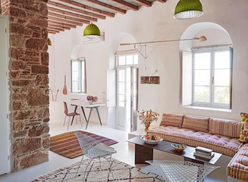 a living room with a couch and a table at Xinara House Old Blacksmiths in Tripótamos