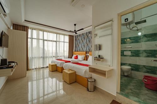 a hotel room with a bed and a bathroom at Priya Residency Pondicherry in Pondicherry
