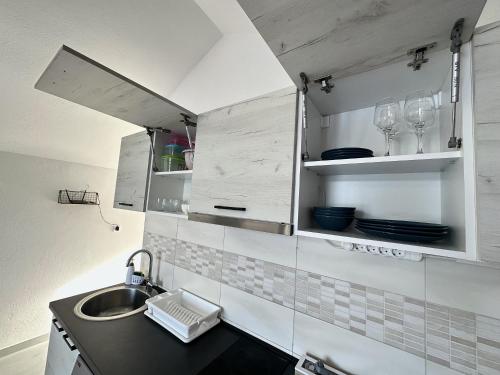 a kitchen with a sink and a counter top at Apartmani Zaliv in Tivat