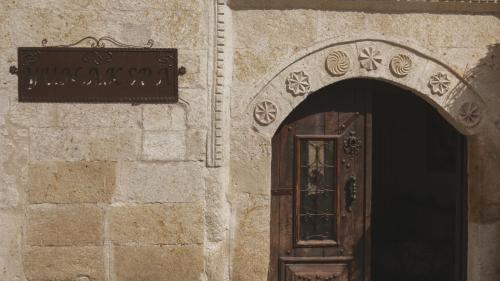an entrance to a building with a wooden door at Yunak Evleri Cappadocia in Urgup