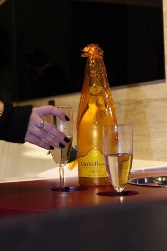 a bottle of wine and two glasses on a table at Conte Luxury Rooms in Salerno