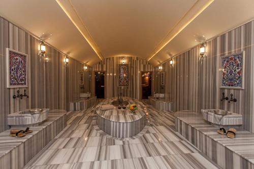 a bathroom with four sinks and a tub in the middle at Yunak Evleri Cappadocia in Urgup