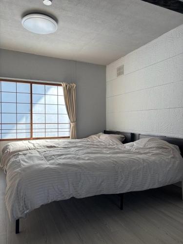 Postel nebo postele na pokoji v ubytování 釧路貸切最大11人戸建静観な住宅街で空港も近い