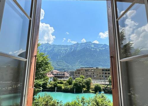 a view of a mountain from a window at River-2 with Iconic Jungfraujoch View in Interlaken