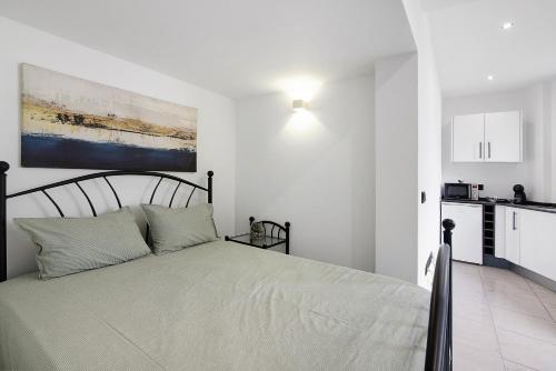 Un dormitorio con una cama y una cocina. en Mi Casa Es Su Casa Nº2, en Albufeira