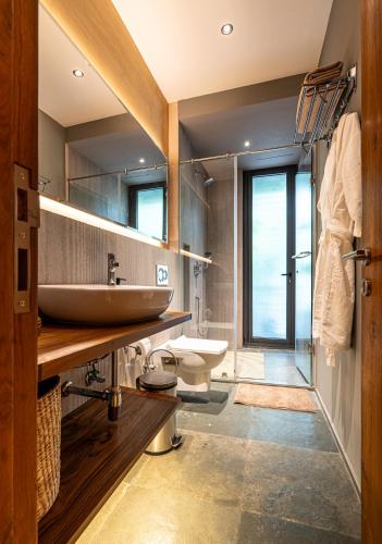 a bathroom with a sink and a toilet at Gulmohar527 3BHK Service Apartment Defence Colony in Jāmb