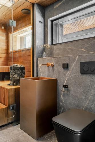 a bathroom with a toilet and a sink at Casa Pickala - The Luxury of life in Hovgård