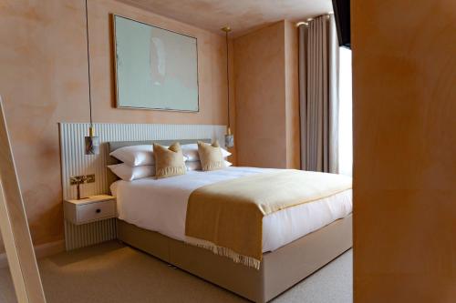 a bedroom with a large white bed with a window at Rooms at 32 in Sligo
