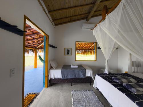 Ένα ή περισσότερα κρεβάτια σε δωμάτιο στο Pousada e camping Filó Caraíva