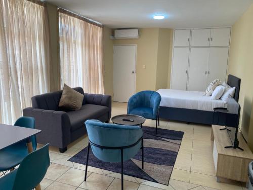 a living room with a bed and a couch at Oceanic 1 Bedroom with Stadium Views2 - Self-Catering Apartment in Durban