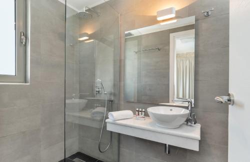 Villa Akoni في ميغانيسي: حمام مع حوض ودش زجاجي